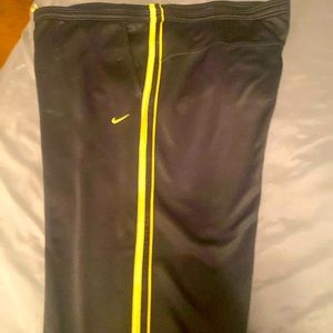 Nike athletic pants/jumpsuit pants size Large Black/gold stripes down each leg.